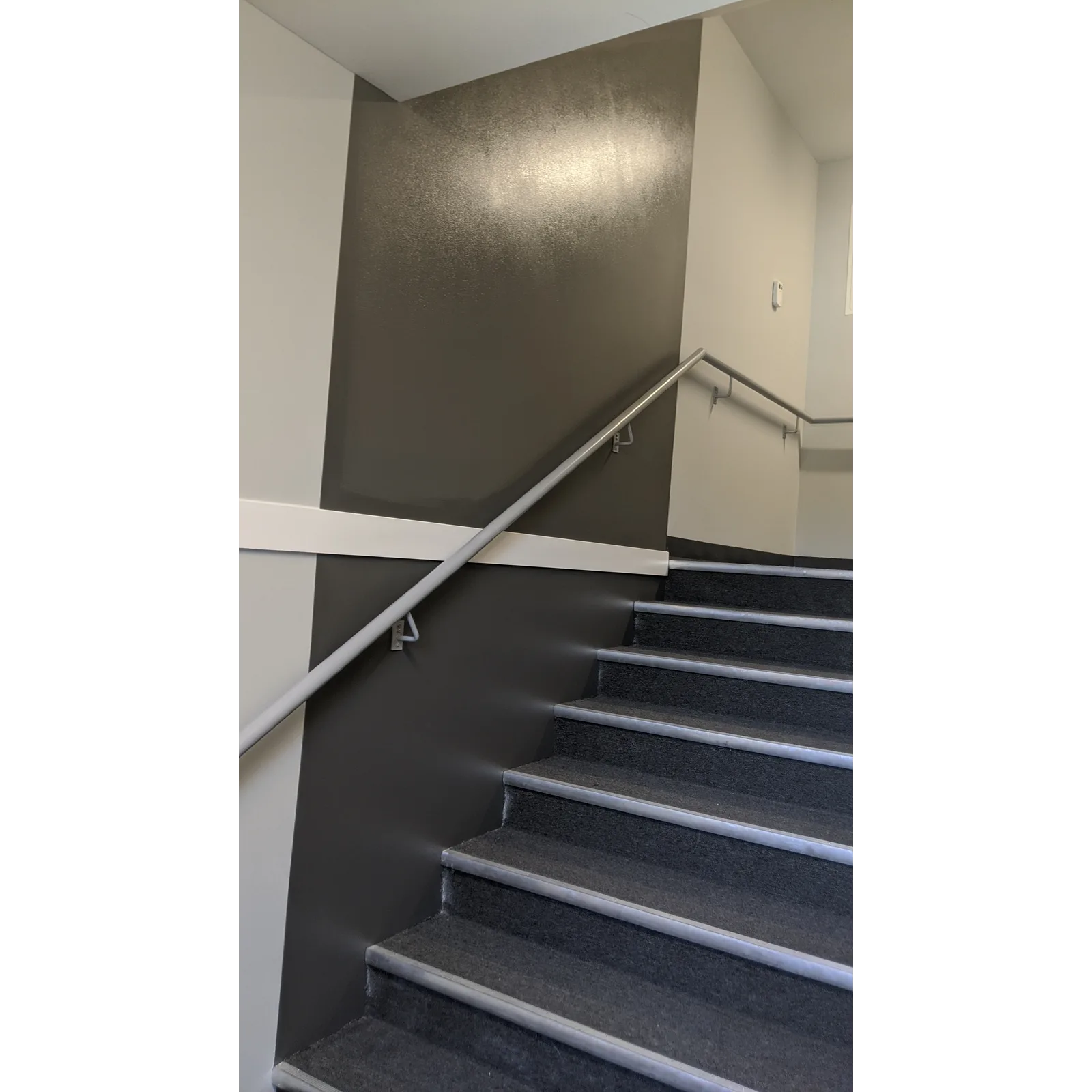 Freshly painted dark wall beside a staircase